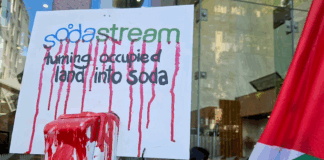 A SodaStream critical placard in today's protest