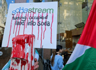 A SodaStream critical placard in today's protest