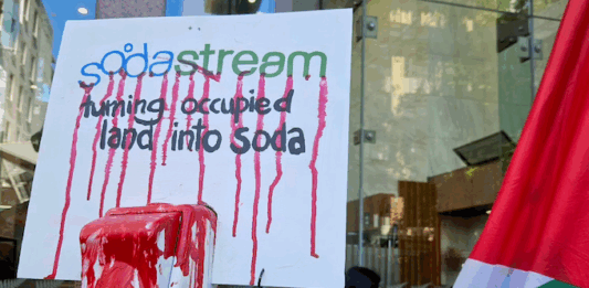 A SodaStream critical placard in today's protest