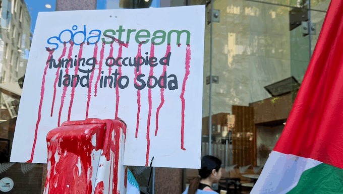 A SodaStream critical placard in today's protest