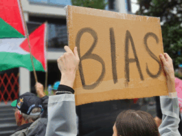A pro-Palestinian protester outside the public broadcaster TVNZ in an Auckland demonstration