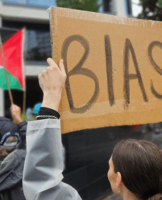 A pro-Palestinian protester outside the public broadcaster TVNZ in an Auckland demonstration