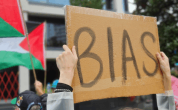 A pro-Palestinian protester outside the public broadcaster TVNZ in an Auckland demonstration
