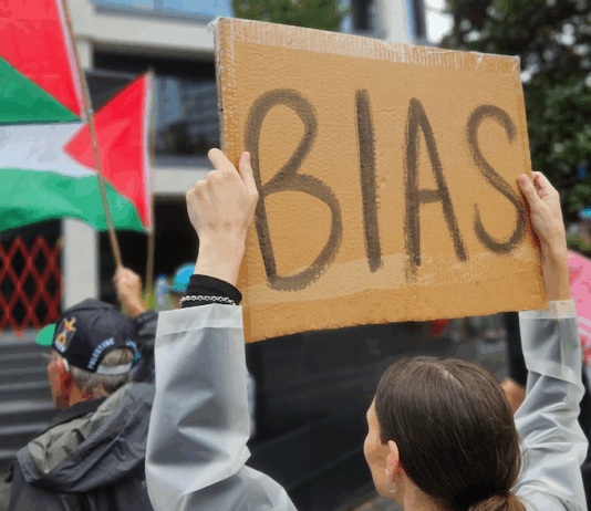 A pro-Palestinian protester outside the public broadcaster TVNZ in an Auckland demonstration