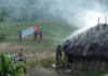 A West Papuan Morning Star flag being held in defiance of the Indonesian ban in a remote village