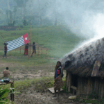 A West Papuan Morning Star flag being held in defiance of the Indonesian ban in a remote village