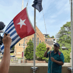 West Papuan supporters raise the Morning Star flag in Leichhardt, Sydney, today as protesters around the world mark the 1 December 1961 "independence" flag-flying day. Image: AWPA