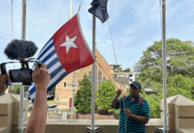 West Papuan supporters raise the Morning Star flag in Leichhardt, Sydney, today as protesters around the world mark the 1 December 1961 "independence" flag-flying day. Image: AWPA