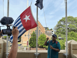 West Papuan supporters raise the Morning Star flag in Leichhardt, Sydney, today as protesters around the world mark the 1 December 1961 "independence" flag-flying day. Image: AWPA