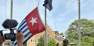 West Papuan supporters raise the Morning Star flag in Leichhardt, Sydney, today as protesters around the world mark the 1 December 1961 "independence" flag-flying day. Image: AWPA
