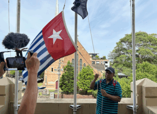 West Papuan supporters raise the Morning Star flag in Leichhardt, Sydney, today as protesters around the world mark the 1 December 1961 "independence" flag-flying day. Image: AWPA