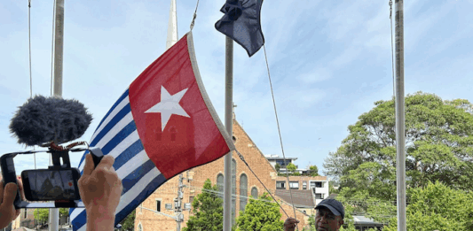 West Papuan supporters raise the Morning Star flag in Leichhardt, Sydney, today as protesters around the world mark the 1 December 1961 "independence" flag-flying day. Image: AWPA