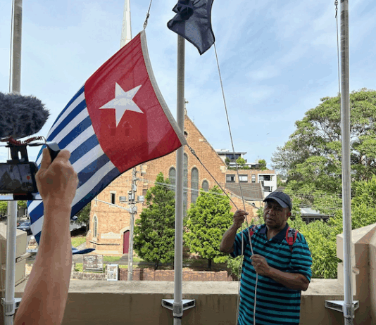 West Papuan supporters raise the Morning Star flag in Leichhardt, Sydney, today as protesters around the world mark the 1 December 1961 "independence" flag-flying day. Image: AWPA