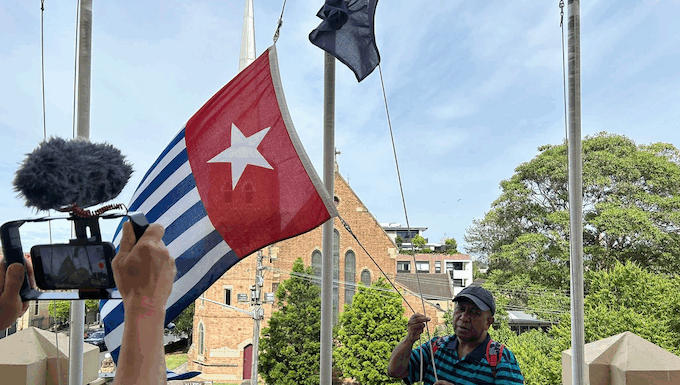 West Papuan supporters raise the Morning Star flag in Leichhardt, Sydney, today as protesters around the world mark the 1 December 1961 "independence" flag-flying day. Image: AWPA