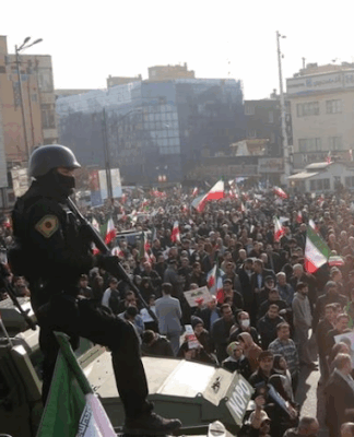 Iranian security forces keep watch on a rally in Tehran.
