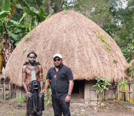 The author, Laurens Ikinia, with a well-preserved mummy from the Hubula tribe in Wamena