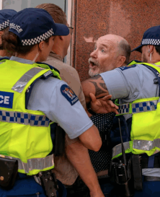Former Wellington mayoral candidate Graham Bloxham being arrested by police at the Venezuela solidarity rally