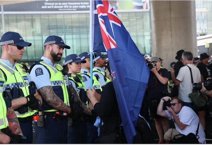 A police cordon faces Destiny Church supporters