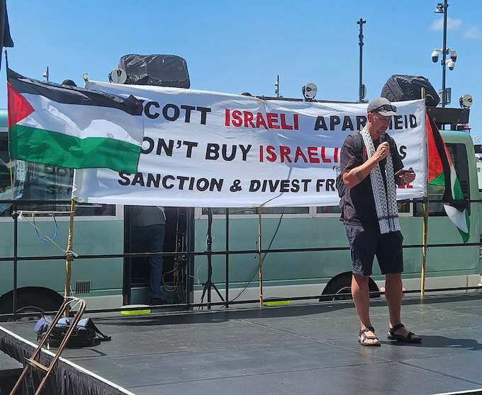 Dr Rand Hazou speaking about Palestinian detainees at today's Auckland rally