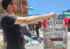 A "release the Palestinian hostages" placard at today's Red Ribbon Campaign protest