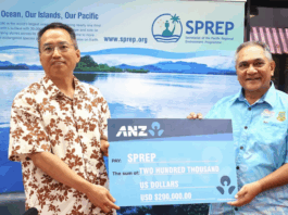 China's ambassador to Samoa Fei Mingxing (left) hands over a ceremonial cheque for US$200,000 to SPREP director of legal services and governing bodies Aumua Clark Peteru in Apia