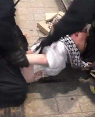 A scene of NSW police brutality raining blows on a young man in a keffiyeh in Sydney