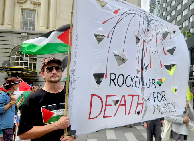 A “Rocket Lab = death for money” banner