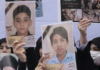 Iranian women hold photos of children who are killed by US-Israeli attacks, including a massacre at a Minab girls’ school that killed around 175 people