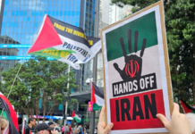 A "Hands Off Iran" placard at the Auckland rally