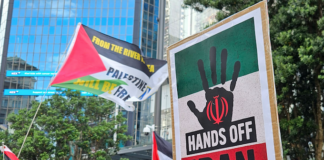 A "Hands Off Iran" placard at the Auckland rally