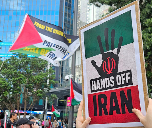 A "Hands Off Iran" placard at the Auckland rally