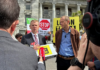 Opposition Labour leader Chris Hipkins (left) receives the Iran war petition from Greenpeace executive director Dr Russel Norman