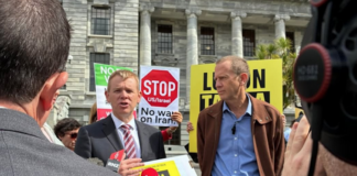 Opposition Labour leader Chris Hipkins (left) receives the Iran war petition from Greenpeace executive director Dr Russel Norman