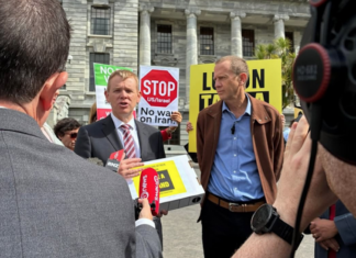 Opposition Labour leader Chris Hipkins (left) receives the Iran war petition from Greenpeace executive director Dr Russel Norman