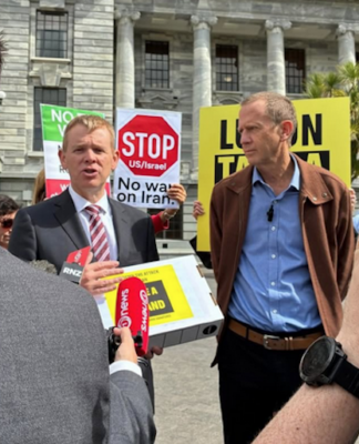 Opposition Labour leader Chris Hipkins (left) receives the Iran war petition from Greenpeace executive director Dr Russel Norman
