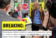 Opposition Labour leader Chris Hipkins (left) receives the Iran war petition from Greenpeace executive director Dr Russel Norman