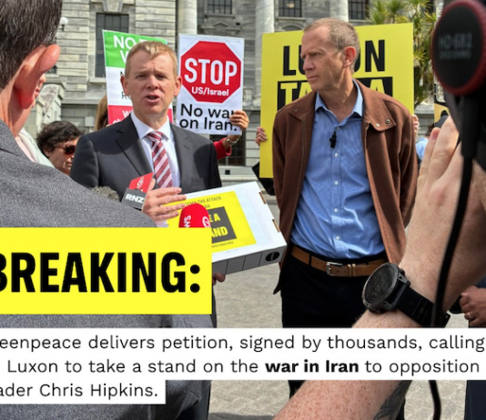 Opposition Labour leader Chris Hipkins (left) receives the Iran war petition from Greenpeace executive director Dr Russel Norman