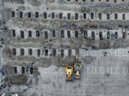 Mourners dig graves for the funeral of 170 children killed in a US-Israeli strike on a primary school