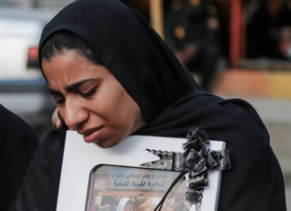 A mourner attends the funeral of child killed in a strike on a primary school in Minab, Hormozgan province, at the start of the US-Israel war on Iran