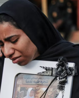 A mourner attends the funeral of child killed in a strike on a primary school in Minab, Hormozgan province, at the start of the US-Israel war on Iran