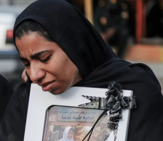 A mourner attends the funeral of child killed in a strike on a primary school in Minab, Hormozgan province, at the start of the US-Israel war on Iran
