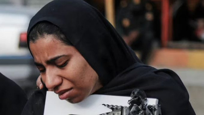A mourner attends the funeral of child killed in a strike on a primary school in Minab, Hormozgan province, at the start of the US-Israel war on Iran