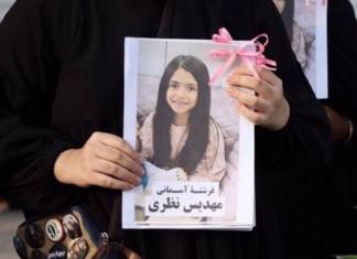 Alternative Jewish Voices: Stop this Iran catastrophe! A mourner holds up a picture of one of the victims of the US-Israeli attack on Iran at Minab