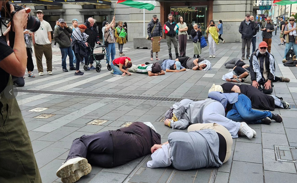 "Tortured Palestinan prisoners" lying on the pavement in the street theatre protest
