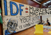 An "IDF = Murder Machine" banner at the "Banners for Humanity" exhibition