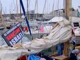 A "New Zealand government must sanction Israel" banner flutters on one of the Global Sumud Flotilla boats
