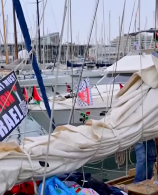 A "New Zealand government must sanction Israel" banner flutters on one of the Global Sumud Flotilla boats