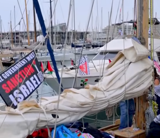 A "New Zealand government must sanction Israel" banner flutters on one of the Global Sumud Flotilla boats
