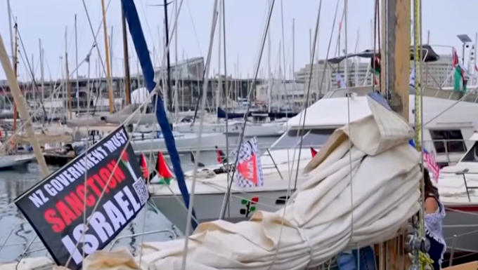 A "New Zealand government must sanction Israel" banner flutters on one of the Global Sumud Flotilla boats