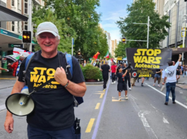 Palestine Solidarity Network Aotearoa's Neil Scott and protesters marching in the Stop Wars Aotearoa rally